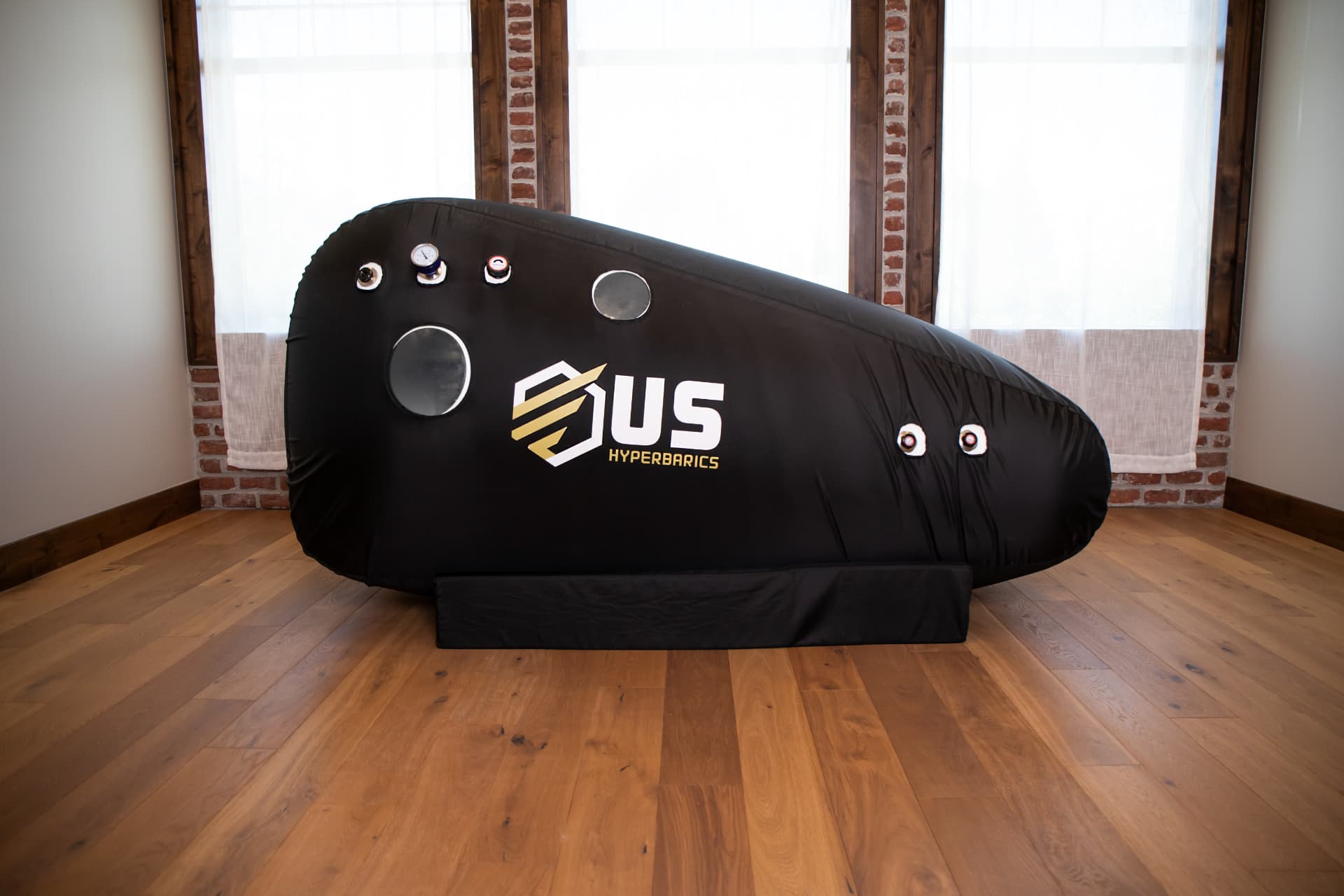 US Hyperbarics chamber installed in a home living space with hardwood floors